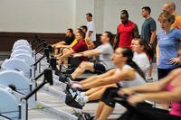 Service members use the rowing machines during a tactical fitness class on Offutt Air Force Base, Neb.