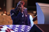 U.S. Air Force personnel stand near the coffin of slain airman Roger Fortson