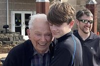 Orville Allen of Poplar Bluff, Mo., hugging his great-grandson
