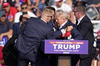 Former President Donald Trump is helped off the stage in Butler, Pa.