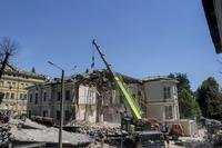 Rescue workers clear the rubble at the site of Okhmatdyt children's hospital hit by Russian missiles