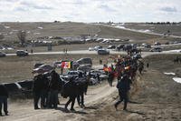 Members of the American Indian Movement walk to the Wounded Knee Massacre Monument in Wounded Knee, S.D.