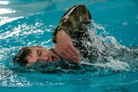 A U.S. Army Reserve paralegal specialist participates in a 100-meter swim during the 200th Military Police Command's Best Warrior Competition at Fort Hunter Liggett, California.