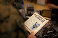 U.S. Marine reads a pamphlet during a SkillBridge expo