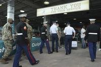 Members of the military enter Hard Rock Stadium before an NFL football game