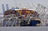 cargo ship Dali is stuck under part of the structure of the Francis Scott Key Bridge after the ship hit the bridge