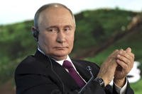 Russian President Vladimir Putin applauds during the Eastern Economic Forum in Vladivostok, Russia