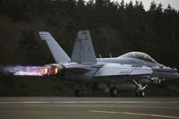 An EA-18G Growler engine's thrust with afterburner propels its takeoff from Naval Air Station Whidbey Island