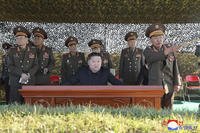 North Korean leader Kim Jong Un, center, watches an artillery exercise