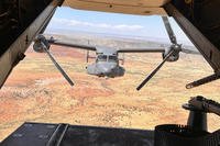 Two Air Force Special Operations Command CV-22B Ospreys fly low and fast in formation on a training range