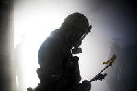 A member of the Japan Ground Self-Defense Force’s 102nd Central Nuclear Biological Chemical Weapon Defense Unit makes his way through a smoke-filled room inside the fire training tower aboard Marine Corps Air Station Iwakuni, Japan.