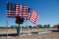 American flags fly at a gravesite at the National Memorial Cemetery of Arizona Monday, Nov. 12, 2018, in Phoenix.