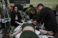 A medic treats an injured Ukrainian serviceman at Medical Service &quot;Ulf&quot;
