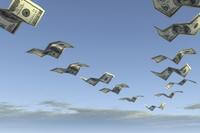 US $100 bills, bent into four sections resembling paper airplanes or birds, fly in a V through the blue sky.