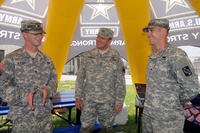 U.S. Army Sgt. Byron Raver, with the 490th Signal Company, explains his company’s mission to the U.S. Army Reserve Deputy Commanding General (Support) Maj. Gen. Glenn J. Lesniak during the Army Reserve Mega Event in Whitehall, Ohio, June 22, 2013, while Sgt. John Baker listens in.