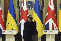 British Prime Minister Keir Starmer, left and Ukrainian President Volodymyr Zelenskyy hug