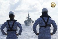 Philippine Navy personnel watch the Canadian vessel HMCS Montrea