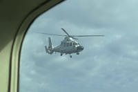 A Chinese military helicopter flies close to a Philippine Bureau of Fisheries and Aquatic (BFAR) aircraft above Scarborough shoal