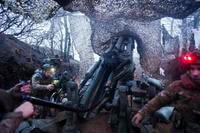 Ukrainian servicemen of 148th artillery brigade fire by a M777 howitzer towards Russian positions