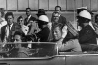 President John F. Kennedy riding in motorcade with first lady Jacqueline Kenndy in Dallas