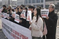 Protesters shout slogans during a press conference demanding to stop the upcoming Freedom Shield military exercise