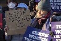 Demonstrators rally in support of federal workers outside of the Department of Health and Human Services