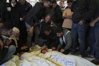 Mourners grieve over the body of Palestinian child