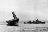 USS Yorktown lists heavily to port after being struck by Japanese bombers and torpedo planes in the Battle of Midway