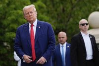 President Donald Trump walks after a news conference at Trump National Golf Club