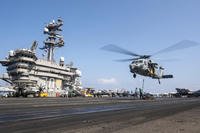 MH-60S Sea Hawk helicopter hovering over the USS Carl Vinson aircraft carrier