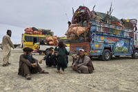 Afghan refugees take rest at a transit station
