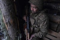 soldier looks out of a shelter on the anti-drone firing position in Kostyantynivka