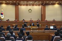 Moon Hyung-bae, center, acting chief justice of South Korea's Constitutional Court, speaks