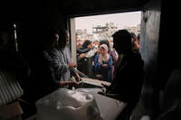 Palestinians receive humanitarian aid distributed by UNRWA, the U.N. agency helping Palestinian refugees in Jabaliya