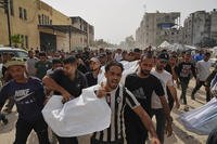 Palestinians carry the bodies of their relatives killed in an Israeli army airstrike.