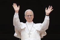 Pope Leo XIV appears at the central balcony of St. Peter's Basilica.