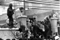 mobs of Vietnamese people scale the wall of the U.S. Embassy in Saigon, Vietnam