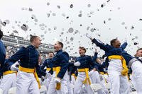 The U.S. Air Force Academy Class of 2025 graduates toss their hats skyward at Falcon Stadium in Colorado Springs