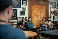 Spouses listen to a briefing.