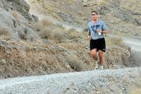 Capt. Richard Kresser, Headquarters Company, 3rd Stryker Brigade Combat Team, 2nd Infantry Division, runs down one of many hills in the ‘Run to Remember’ half-marathon (13.1 miles) at Forward Operating Base Masum Ghar, Afghanistan.