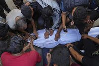 Relatives mourn over the body of Palestinian Bilal Abu Amsha.