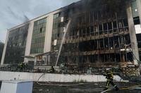 Rescue workers put out a fire of a building damaged by a Russian drone strike on Kyiv, Ukraine
