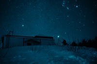 An astronomer at the Special Astrophysical Observatory in the Caucasus Mountains takes a photo of Orion's Belt, which is seen at the background.