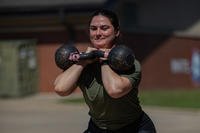 1st Lt. Molly Reagan, assigned to the 3rd Brigade Combat Team, 82nd Airborne Division, performs kettlebell front squats as part of the 'Strongest All American' weightlifting competition during All American Week 2024 at Fort Liberty, North Carolina.