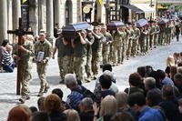 Ukrainian soldiers carry the coffins of 12 Ukrainian servicemen and prisoners of war who died while being held captive in Russia, during a funeral ceremony in Lviv, Ukraine, on July 25, 2025, amid the Russian invasion of Ukraine.