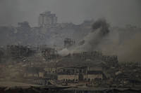 Smoke rises amid destroyed buildings following an Israeli shelling in the Gaza Strip