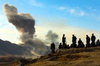 Northern Alliance soldiers watch as U.S. air strikes attack Taliban positions