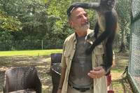 Louie the spider monkey climbs on John Richard, a volunteer at the Gulf Coast Primate Sanctuary in Perkinston, Mississippi