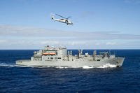 A U.S. Navy Sikorsky MH-60S Sea Hawk helicopter assigned to Helicopter Sea Combat Squadron (HSC) 21 maneuvers toward the U.S. Military Sealift Command dry cargo and ammunition ship USNS Cesar Chavez (T-AKE-14) during a vertical replenishment with the amphibious assault ship USS Peleliu (LHA-5), not pictured, in the Pacific Ocean.