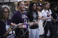 Relatives of Israeli hostages who are being held in the Gaza Strip chain themselves together during a protest.